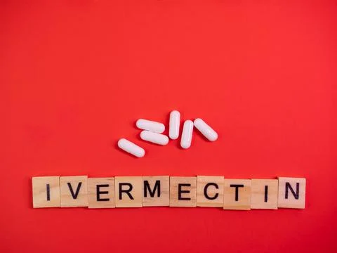 Ivermectin on colored red paper texture background. Ivermectin antiparasitic  Stock Photos