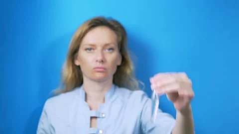 IVF concept. The embryologist holds a test tube in his hand. on blue background Stock-Footage 113041292