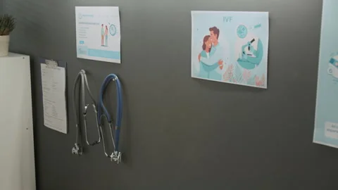 IVF Posters, Two Stethoscopes, Medical Document on Grey Wall in Doctors Office Stock Footage 333682799
