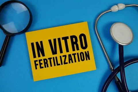 IVF In Vitro Fertilization text with Stethoscope and magnifying glass on bl.. Stock Photos
