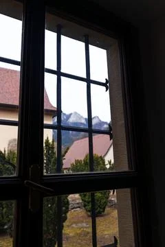 IView Through Barred Window Toward Village Houses and Mountain Landscape Fotos de archivo