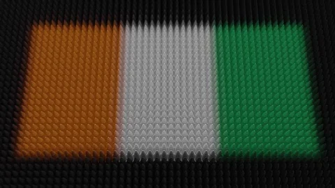 Ivorian Flag Light Shining on Scrolling Bullets Stock Footage 290991294