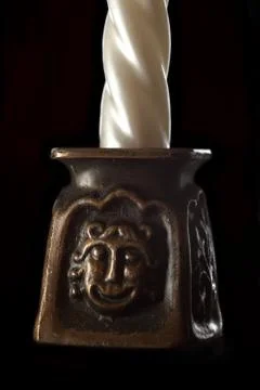 Ivory candle in candlestick Stock Photos