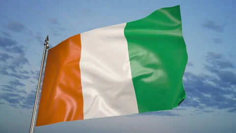 Ivory Coast flag on a flagpole. 3D animation against a blue sky with clouds Видео 205004122