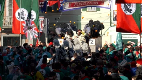 Ivrea, 02-03-2025. Violent battle of the oranges erupts at the Ivrea Carnival. Stock Footage 326523145