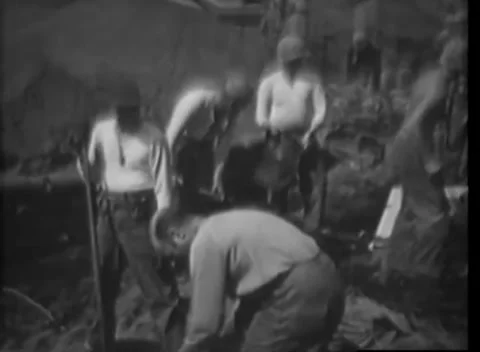 IWO JIMA - 1945: Beachhead — Work party digs across open volcanic ground Видео 342981281