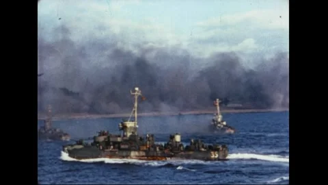 IWO JIMA - 1945: A screening ship maneuvering amid battle smoke Stock Footage 339215199