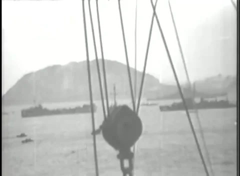 IWO JIMA - 1945: Shipboard — Rigging frames Iwo Jima anchorage Stock Footage 342981809