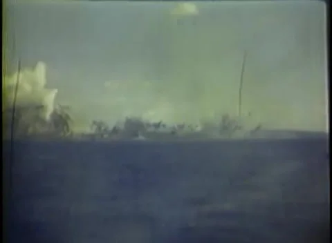 IWO JIMA, JAPAN - 1945: Shell impact - Smoke burst rises from the shoreline Stock-Footage 344507018