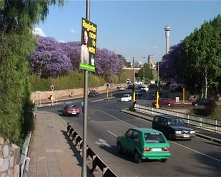 Jacaranda Trees on Busy Road and ANC Election Poster, Johannesburg early 2000s Видео 8664912