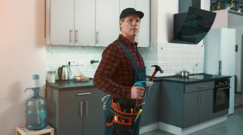 Jack of all trades. Man solves small household problems Stock Photos