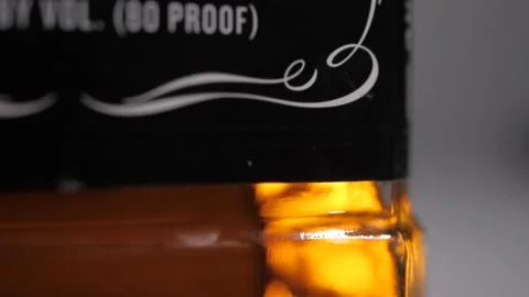 Jack Daniel's Bottle (Macro), Tilt Down Stock Footage 220755598