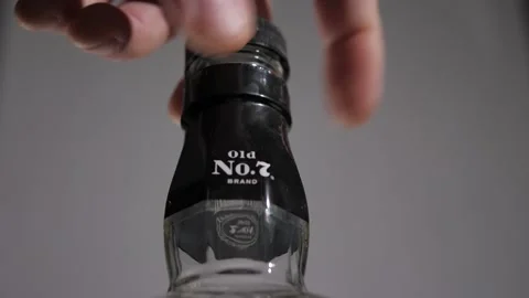 Jack Daniel's Bottle (Macro),Taking Lid Off And Picking Up Bottle ILong Clip) 库存影片 220755608