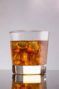 Jack Daniels No. 7 large shot glass with a glare and with the brand name, isolat Stock Photos