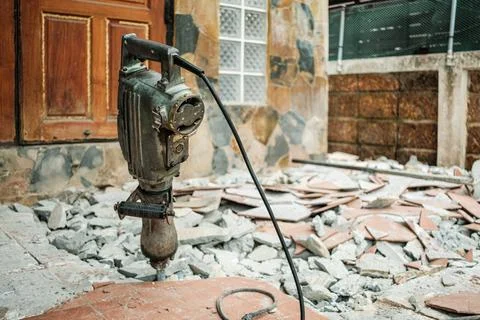 Jack hammer machine break concrete floor for renovation Stock Photos
