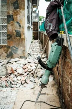 Jack hammer machine break concrete floor for renovation Stock Photos