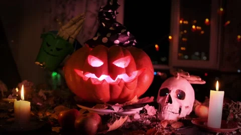 Jack Lantern stroking skull and holding candies bucket during the Halloween Stock Footage 283984358