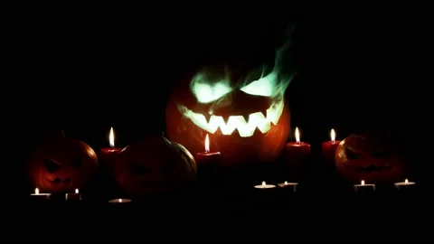Jack-o-lantern with 3 small pumpkin. Candles. Mystical light. Halloween. Stock Footage 141857237