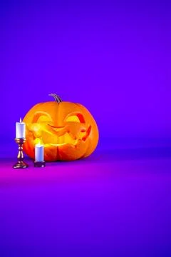 Jack o lantern and candles on purple Halloween background with copy space Stock Illustration