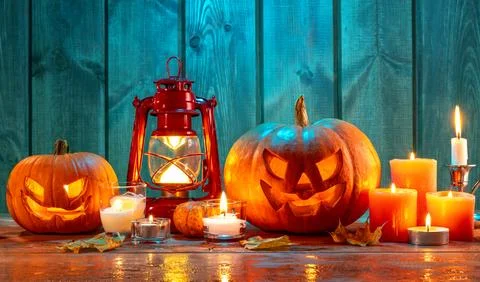 Jack-o-lantern candles, lantern and leaves in dramatic lighting, halloween .. Stock Photos