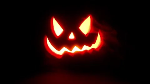 Jack O Lantern Face pulsing in the dark, Halloween intro or credit footage. Stock Footage 250465426