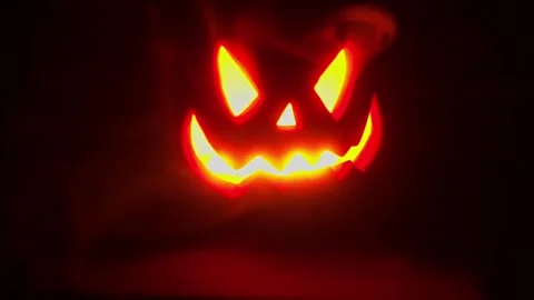 Jack O Lantern Face pulsing in the dark, Halloween intro or credit footage. Stock Footage 250465460