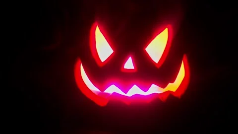 Jack O Lantern Face pulsing in the dark, Halloween intro or credit footage. Stock Footage 250465476