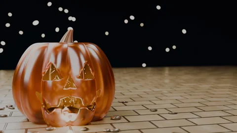 Jack-o'-lantern on golden brick pathway in dark surroundings, 4K Stock Footage 346119846