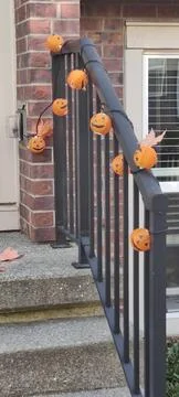 Jack-o-lantern lights on a step railing Stock Photos