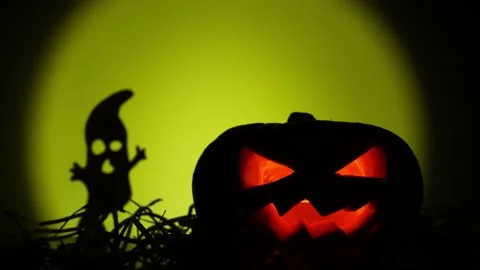 Jack o' Lantern at night. Horror silhouettes moving by it Stock Footage 219505479