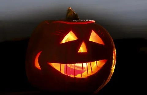 Jack O Lantern at night with the Moon. Stock Photos