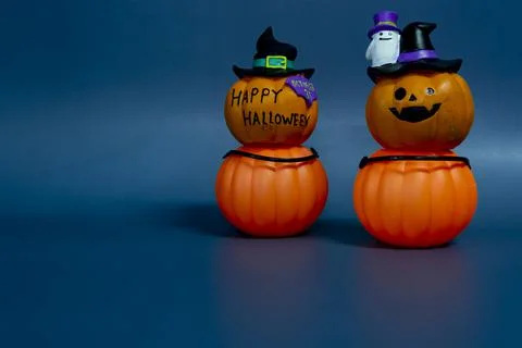 Jack o lantern pumpkin on a dark blue background. Halloween concept backdrop Stock Photos