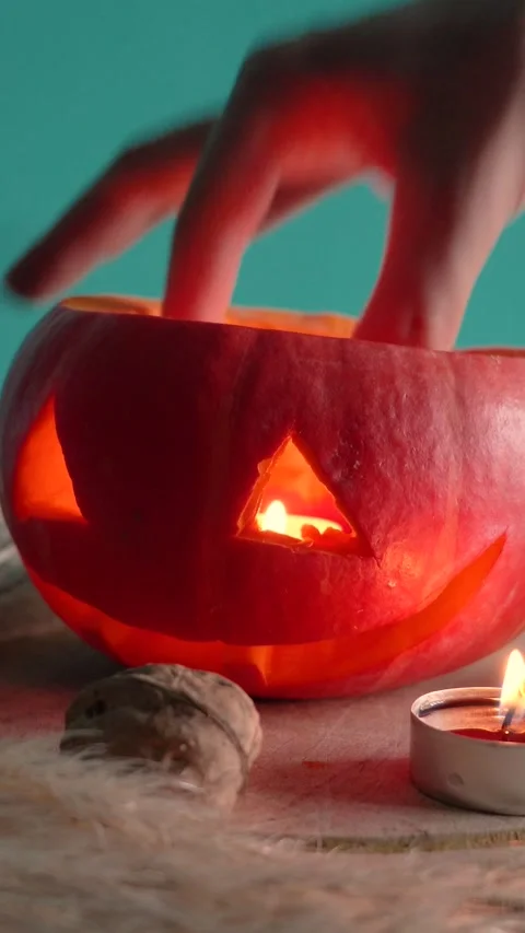 Jack-o-lantern pumpkin on Halloween holiday glows, with candles Stock Footage 286417156