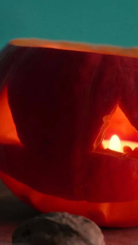 Jack-o-lantern pumpkin on Halloween holiday glows, with candles Stock Footage 286417406