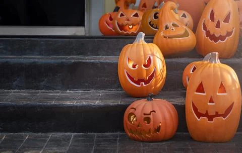 Jack-o-lantern pumpkins on the back porch. Halloween decorations Stock Photos