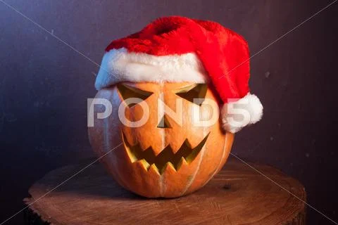 Jack-o ' - lantern in a red Santa hat Stock Photos