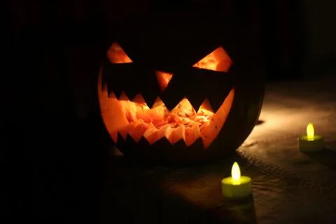 Jack-o'-lantern, scary face carved in pumpkin Stock Photos