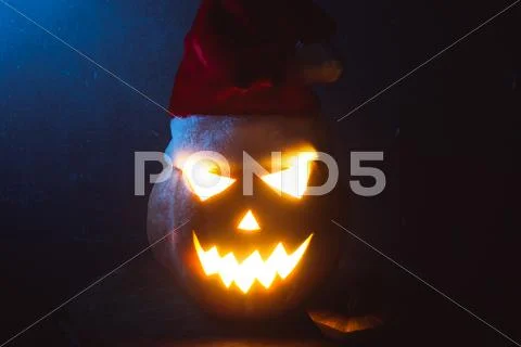 Jack-o ' - lantern scary shining eyes in the darkness Stock Photos