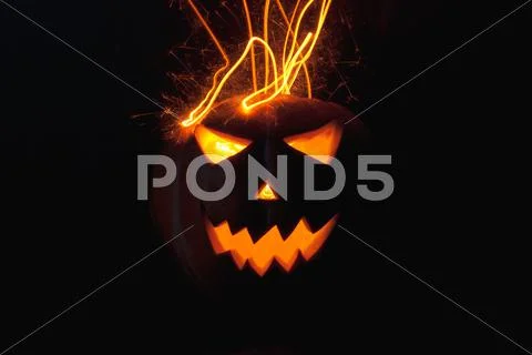 Jack-o ' - lantern scary shining eyes in the darkness Stock Photos