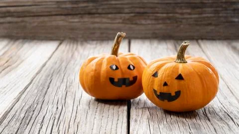A jack-o-lantern set against an old tree Stock Photos