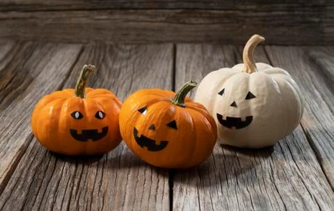 A jack-o-lantern set against an old tree Stock Photos