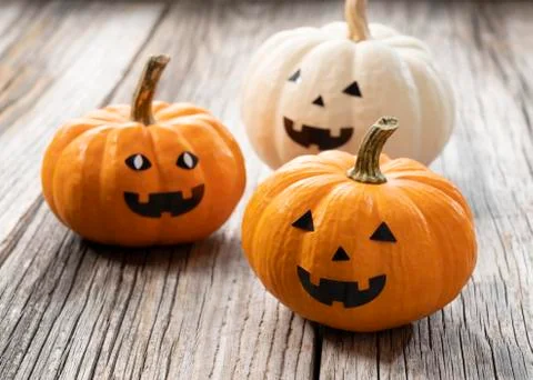 A jack-o-lantern set against an old tree Stock Photos