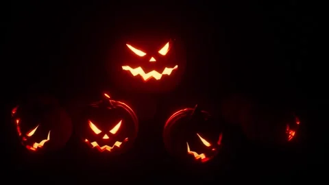 Jack-o-lanterns glow and dance, animated on the beat, seamless loop halloween Stock Footage 345600910