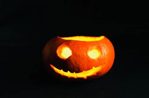 Jack-o-lanterns without cover, with a evil face on the black background Stock Photos