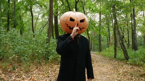 Jack Pumpkinhead in the forest. Finger picking his nose. Video stock 116500374