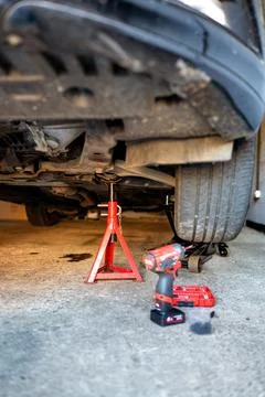 Jack stands under the car during repair vehical. Safety oil changing. Stock Photos