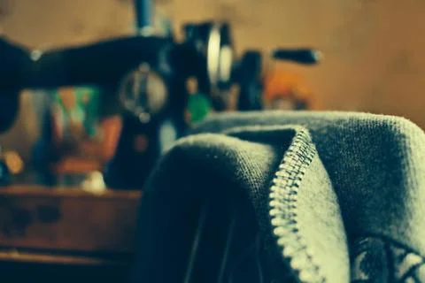 Jacket close up on back of chair on blurred background of hand sewing machine Stock Photos