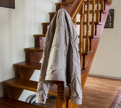 The jacket is hanging on the stairs Stock Photos