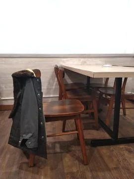 A jacket in a minimalist cafe interior Stock Photos