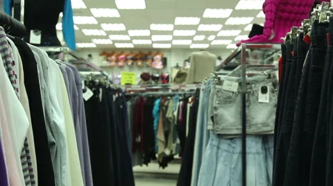 Jackets and jeans on hangers in store Stock Footage 58219476